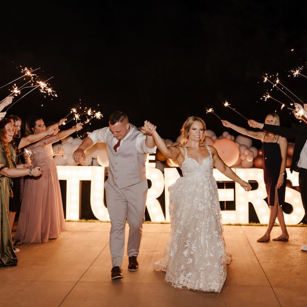 Utah couple celebrates their marriage with sparklers during their October wedding.