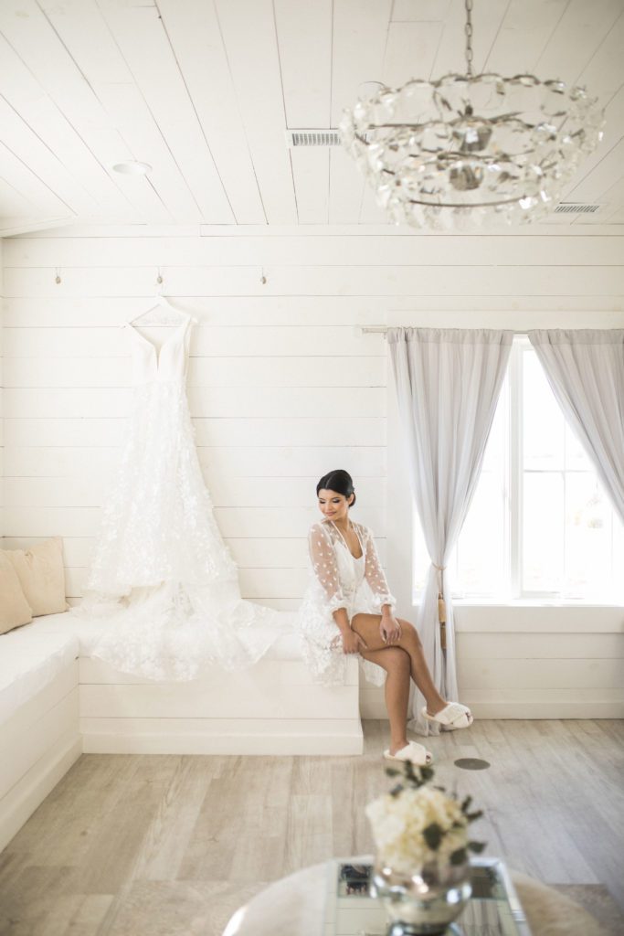 Bride admiring her dress in the bridal suite at providence vineyard