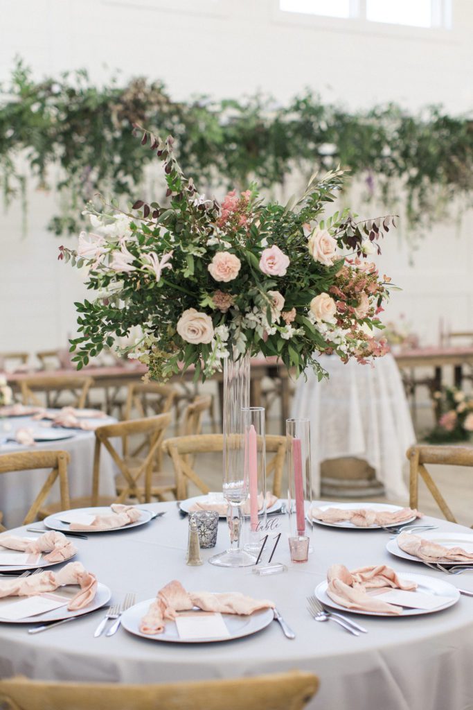 Tall floral centerpieces with pink candles at providence vineyard
