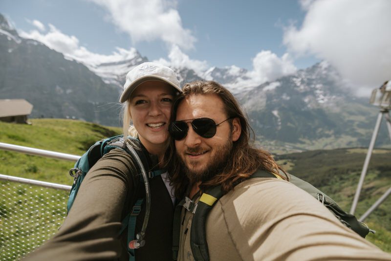 Couple smiles for photo in Switzerland.